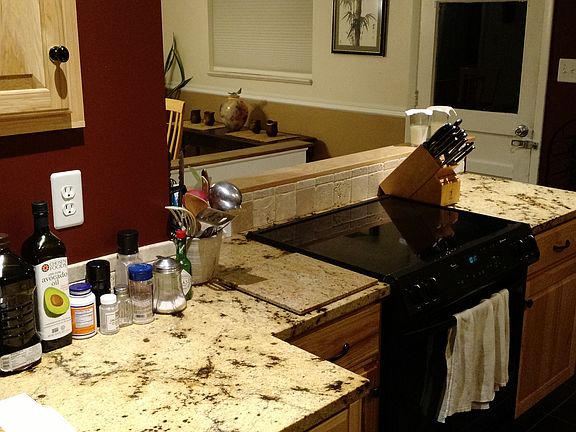 Kitchen cooking area. Black glass stove top.
