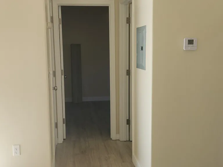 Hallway view from front door. Goes to the rooms/bathroom