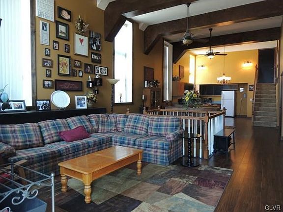 View from front door with staircase in center that leads down to lower level den/office space w/ separate entrance