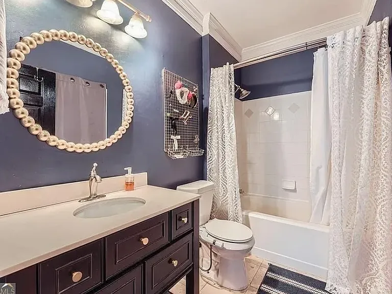 Nice sized, tiled bathroom with bath and shower.