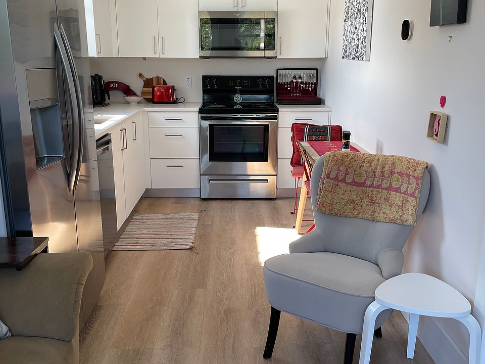 Kitchen with quartz countertops, soft close cabinets and stainless steel appliances.