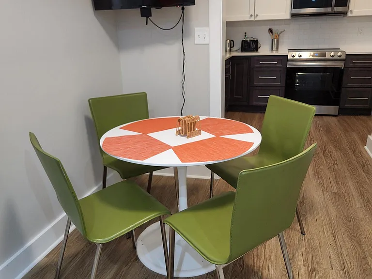 Seating for four, looks into large, separate kitchen area.