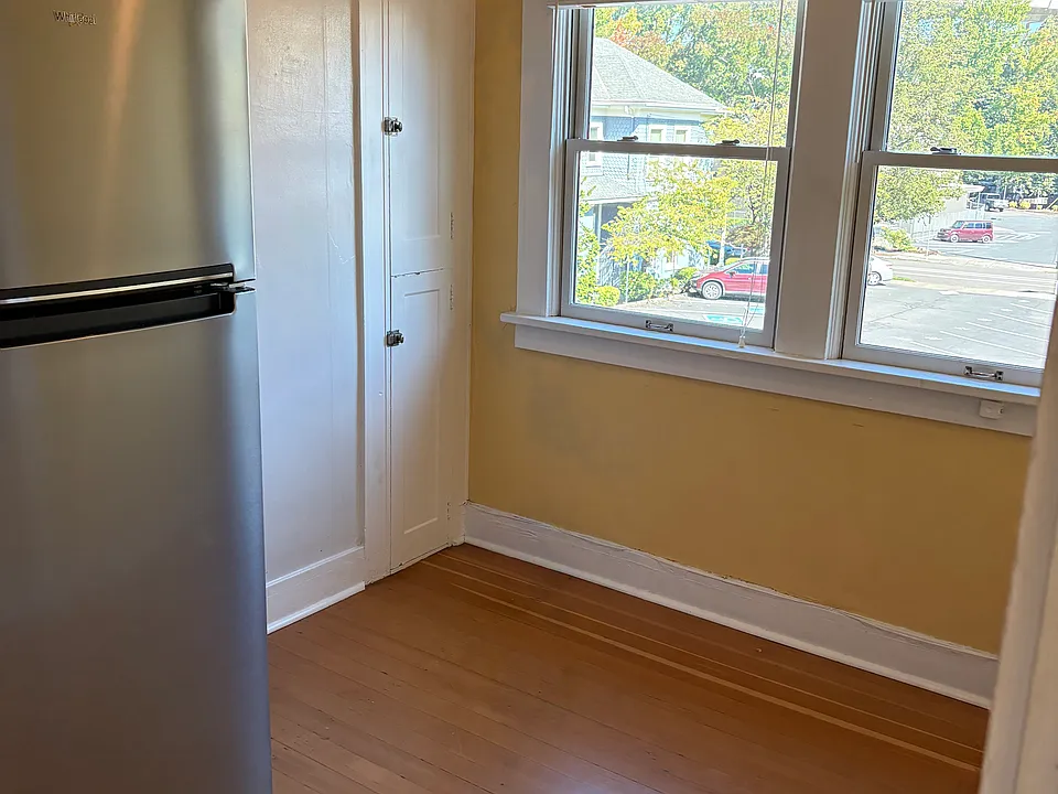 Looking to right, towards windows in kitchen. Many people set up a small table or desk here for enjoying morning coffee or talking while working in kitchen.