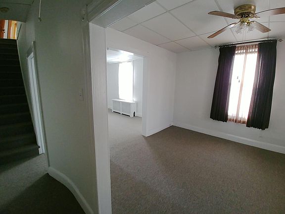 Inside the foyer, looking into the Living Room and through to the Dining Room. Far left is the stairway to the second floor Bedrooms and Bath.