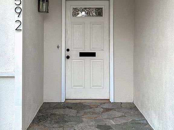 Front door with stone walkway