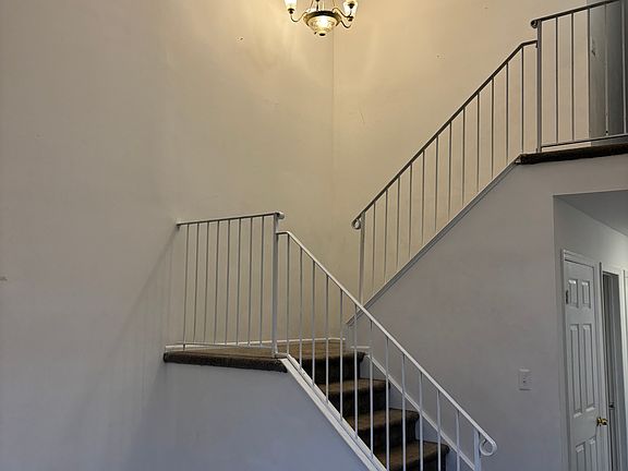 Inside, winding staircase with beautiful chandelier and high ceiling (unique feature not many have in the area)