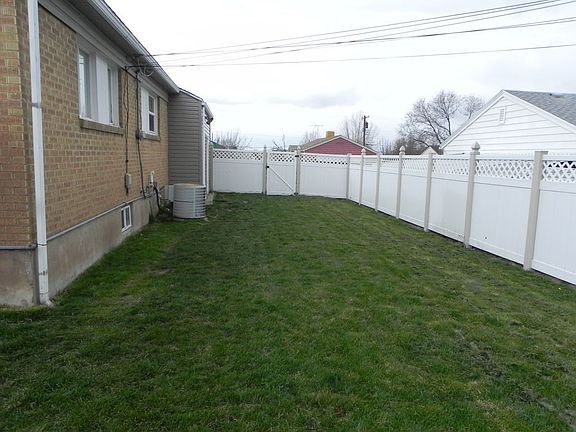 Backyard showing vinyl fence.