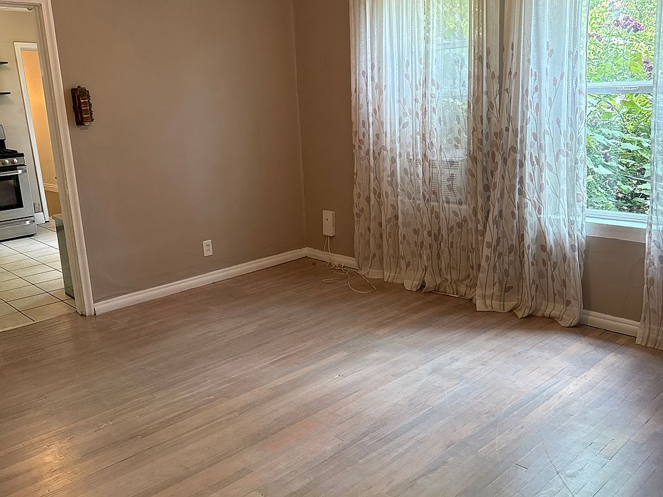 Living room with wood floors, fan and large windows!