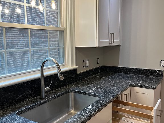 Brand new wooden cabinets with nice features like pull out cabinets, lazy susan, etc. Modern lighting, honed granite countertops, large bowl sink with garbage disposal.