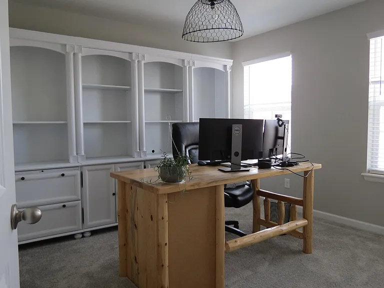 Bedroom 1: Front of house, two windows, walk-in closet