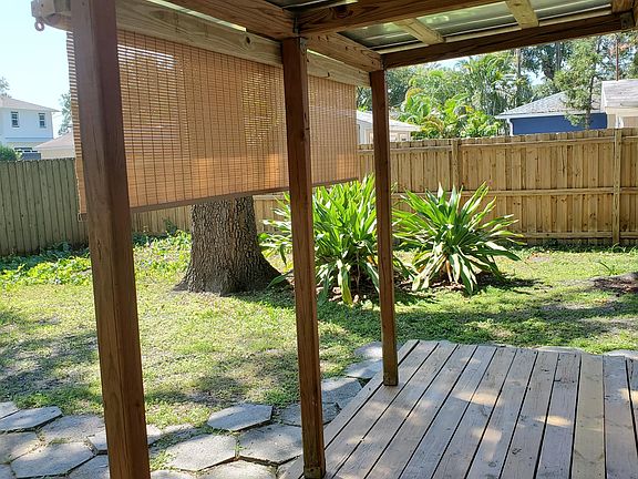 Covered deck with privacy shade that drops all the way down. Privacy fenced backyard.