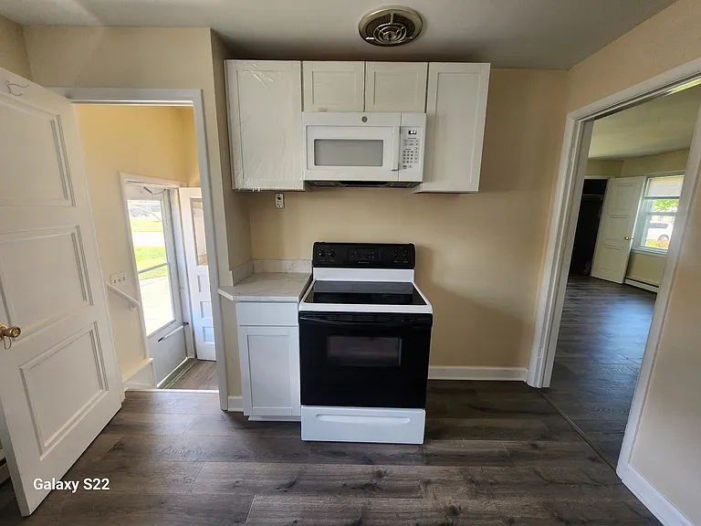 Kitchen (side entrance of house to left and dining area to right).