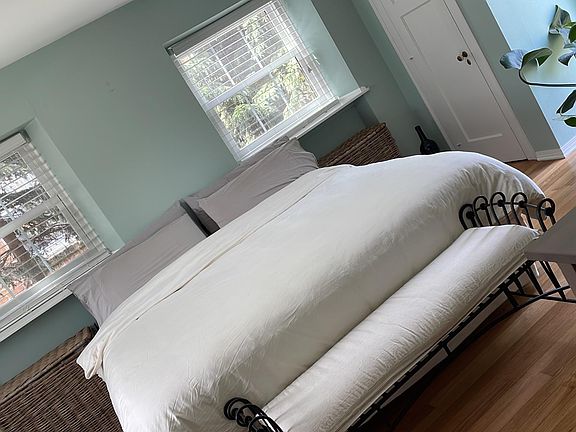 Master bedroom with large picture window and king sized bed