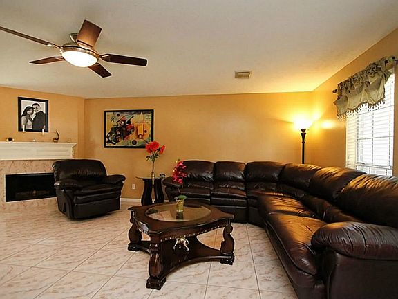 Huge Living/Family Room has Great Gas Log Fireplace, Neutral Paint,  Ceiling Fan  + 18" Tile throughout 1st Floor!