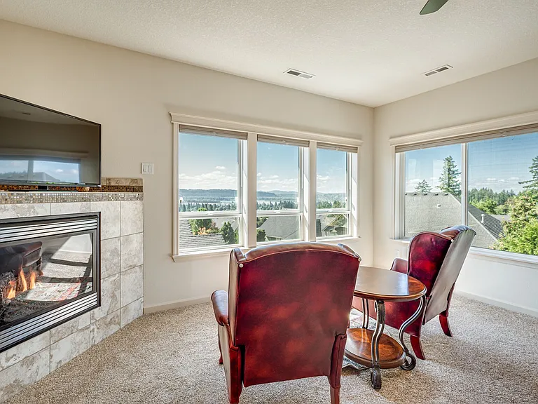 Lots of space in the large primary suite, featuring a walk-in closet, seating area, and dream worthy view