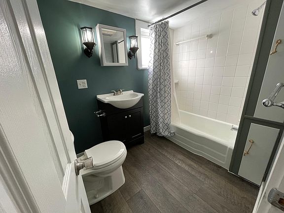 The bathroom, recently updated with new lights, sink, and paint.