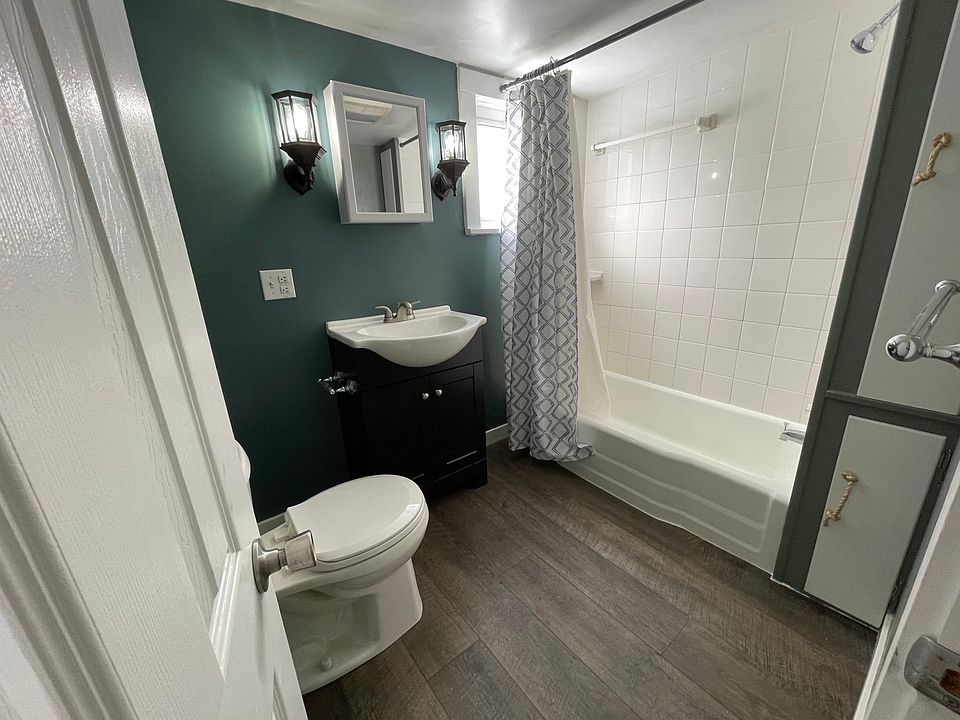 The bathroom, recently updated with new lights, sink, and paint.