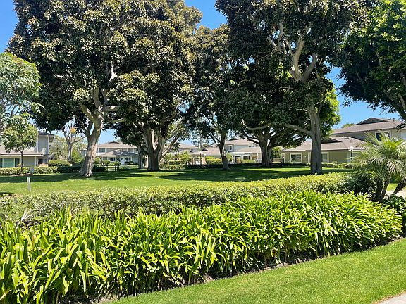 View looking across green belt to the pool and clubhouse. Greenbelt area in the middle of the complex can be used for activities such as corn hole, Croquet, badminton BBQetc.