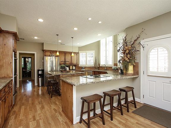 Enter from a side door in rear off driveway close to garage. The large counter overhang allows extra seating space in breakfast area.