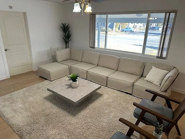 Spacious living room with abundant natural light and open seating area