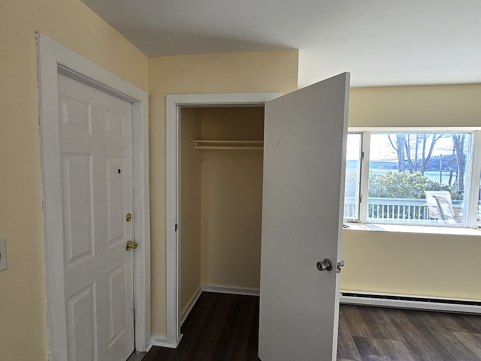 Front door, coat closet, living room window