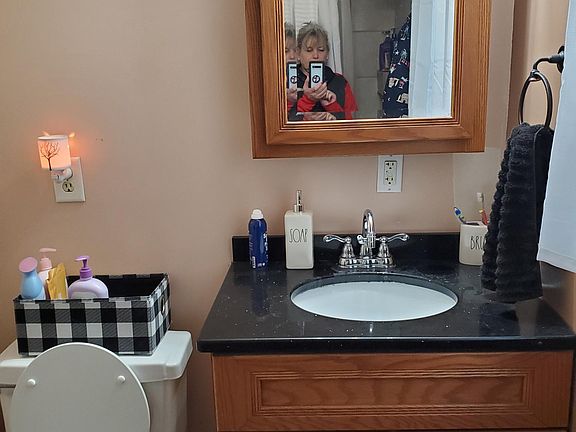 Downstairs bathroom vanity & toilet.