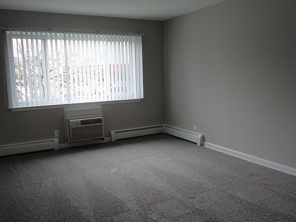 Living room, faces Ogden Av. southern exposure. Grey walls freshly painted, new grey carpeting