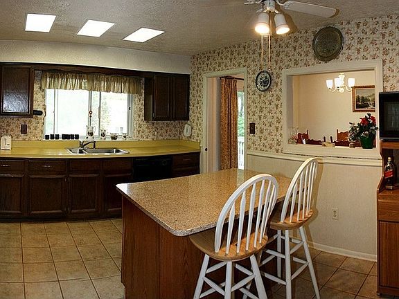 Kitchen with Ceramic Tile and Granite Island