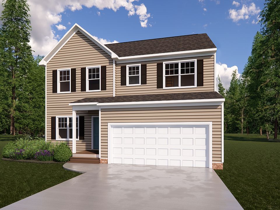 Nestled in Poplar Village, this two-story house features beige siding, white trim, and a two-car gar