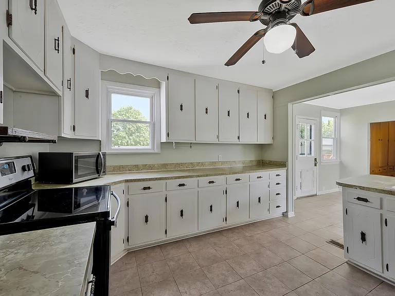 Photo 11. Open Kitchen, dining area and back door leading to deck