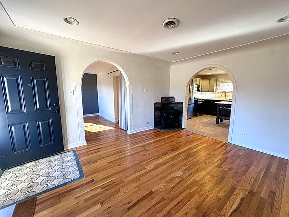 View from main living room towards arches that go to kitchen and 1 bedroom/office/extra living room