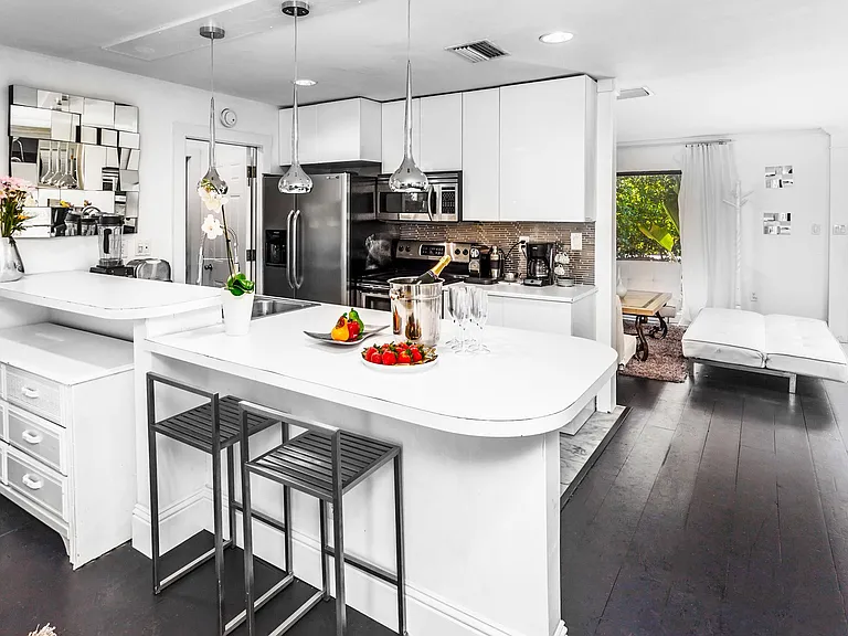 Kitchen fully equipped with modern appliances.