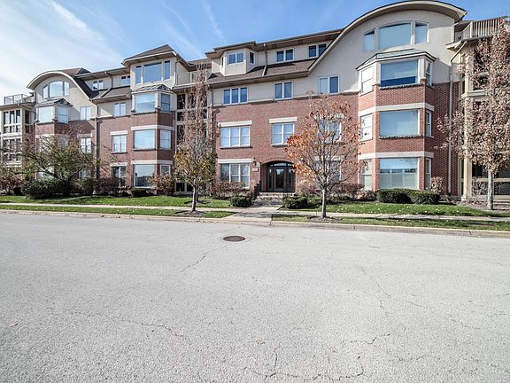 200 N River building. Secure with underground heated parking. Penthouse condo # 402 is above the entry doors, to the left.
