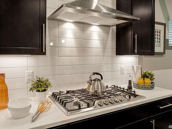 Chef's stoves with SS hood vent. Photo is from model home with the same floor plan and used for demonstration purposes only.