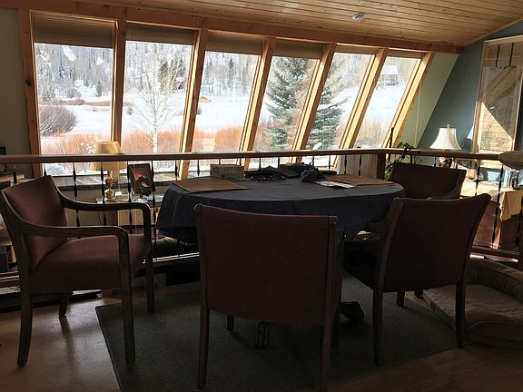 dining and living room & 12 large windows providing a passive solar home, south-west