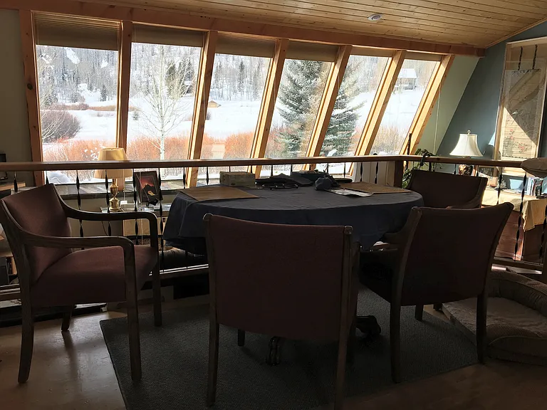 dining and living room & 12 large windows providing a passive solar home, south-west