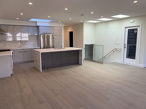 Open Plan kitchen and living/dining area - with door to private roof deck