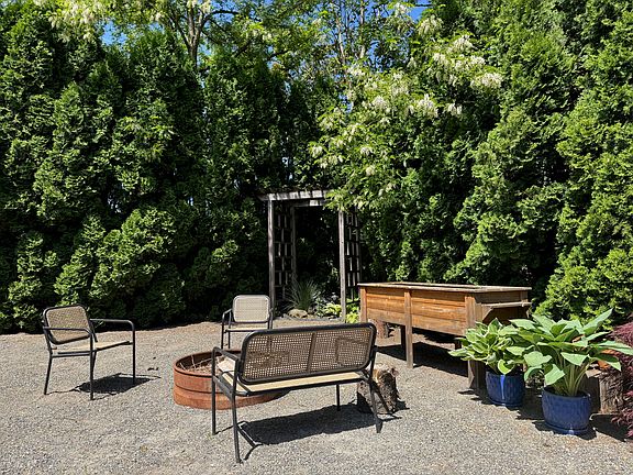 Back yard, raised beds, fireplace and furniture included