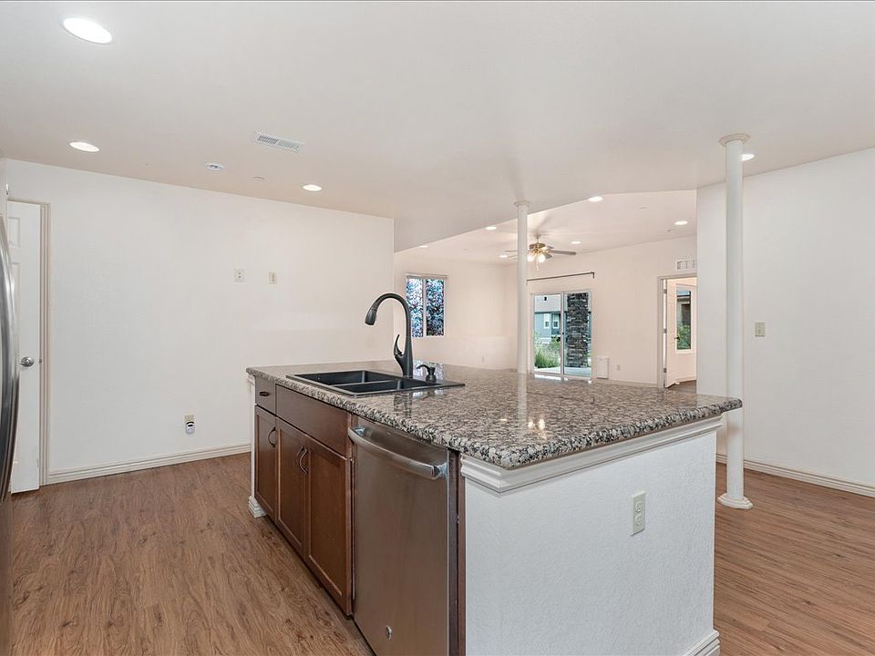 Kitchen with lots of granite countertops and cabinets.