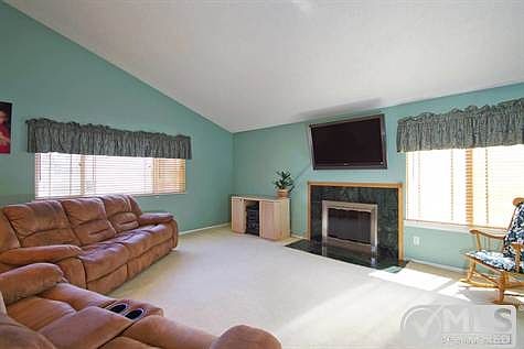 large living room with fireplace & vaulted ceilings. Could be living room, dining room combo