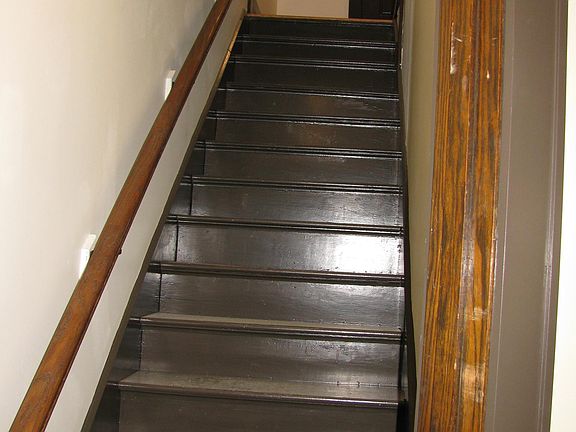 Stairs to upstairs apartment on other side of door.
