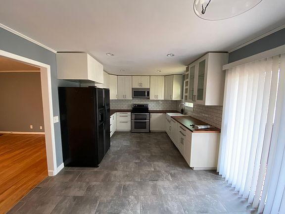 Beautiful kitchen with lots of cabinet space, double oven, dishwasher, microwave, wine rack and more!