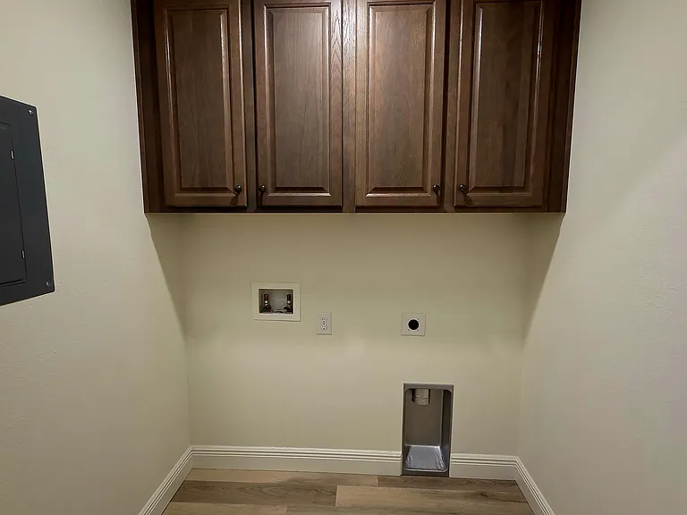 Hallway laundry with cabinets