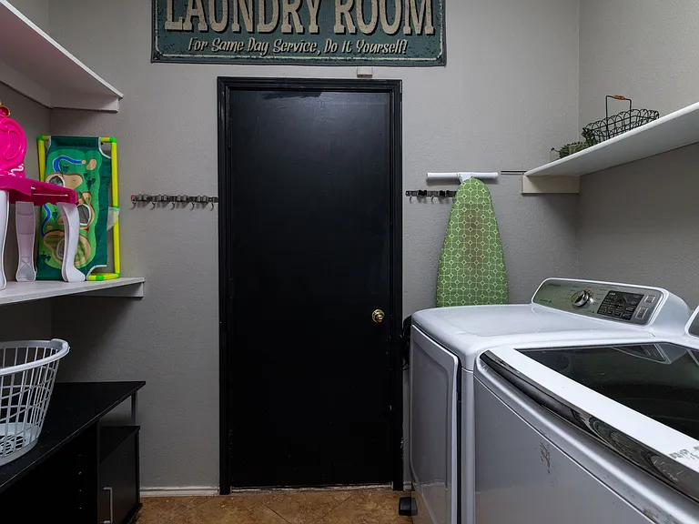Convenient in-unit laundry room with modern appliances.