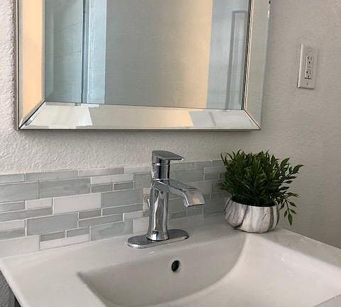 Closer look at the bath vanity top, beautiful glass/marble /tile backsplash.