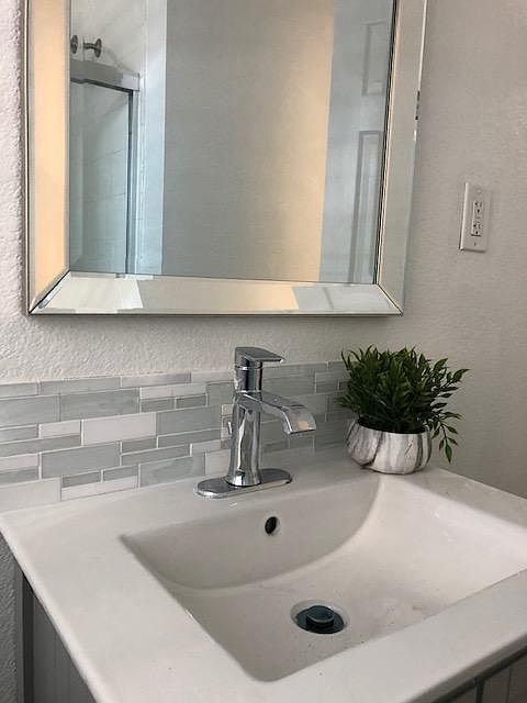 Closer look at the bath vanity top, beautiful glass/marble /tile backsplash.