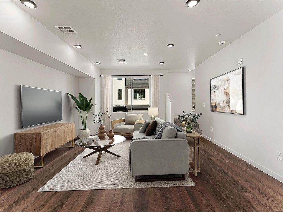 Elegant living room with modern decor, large windows for natural light, cozy seating, and stylish wooden flooring.