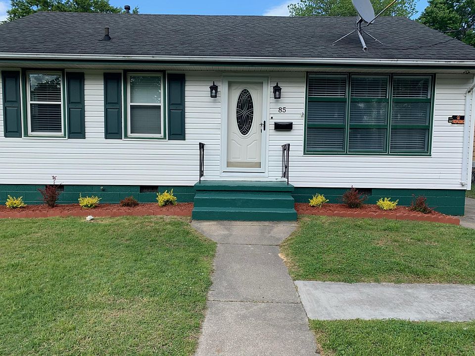 Front view of the home beyond the fence.