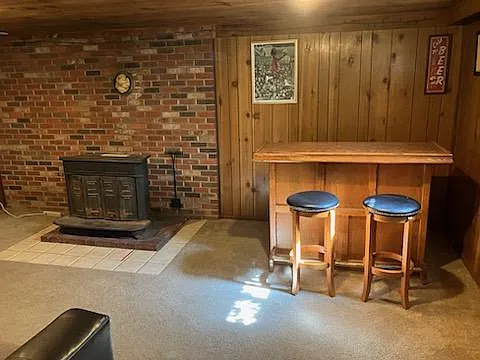Basement view looking at bar and fireplace