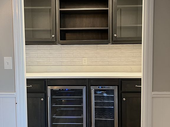 Custom bar in den with wine fridge and small beverage fridge/